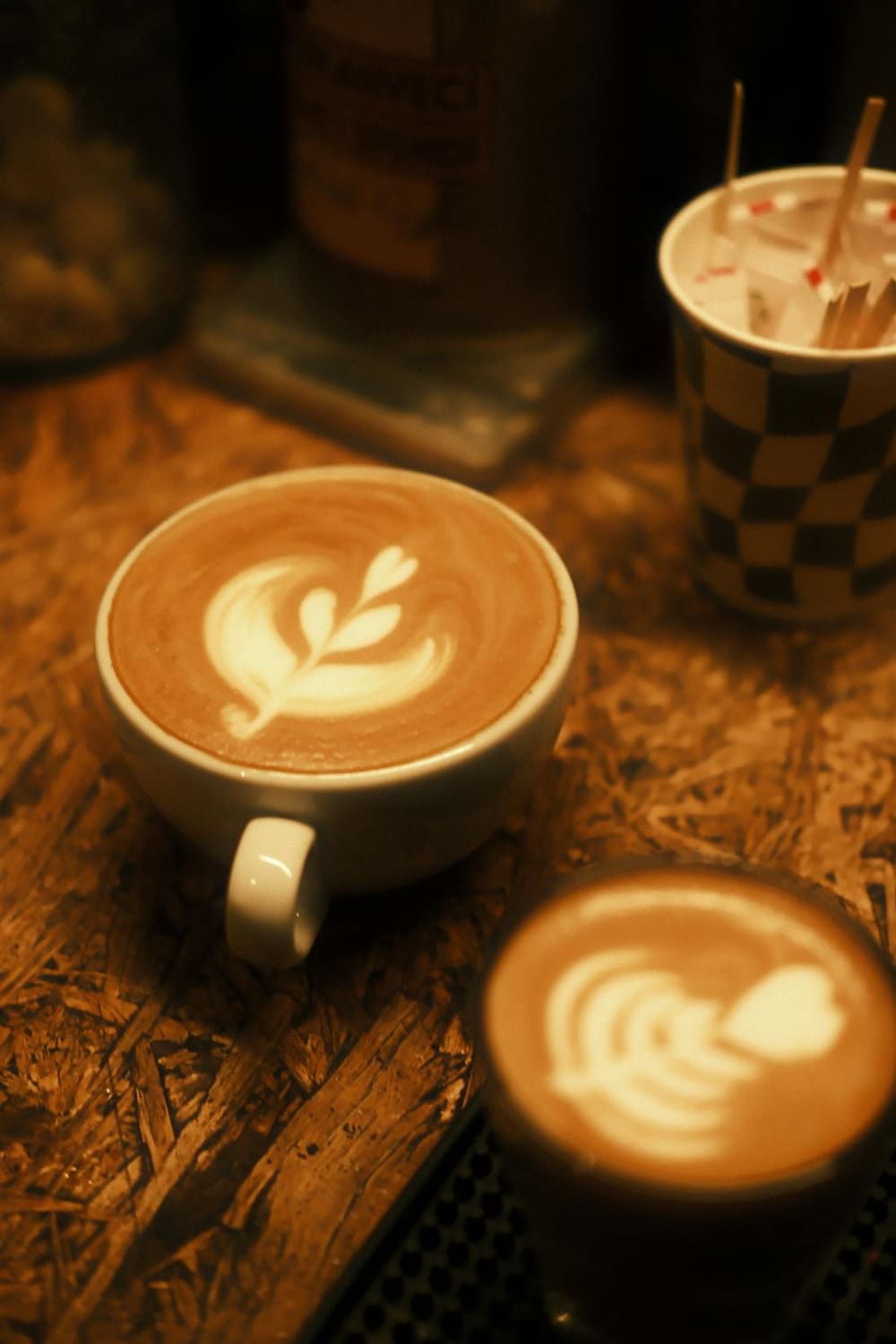 A latte with leaf art in a warm cafe