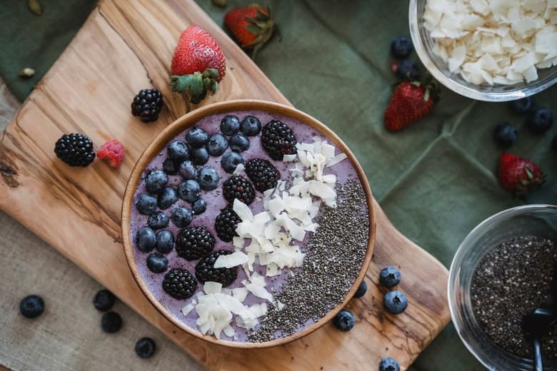 An acai bowl topped with fresh fruit and granola